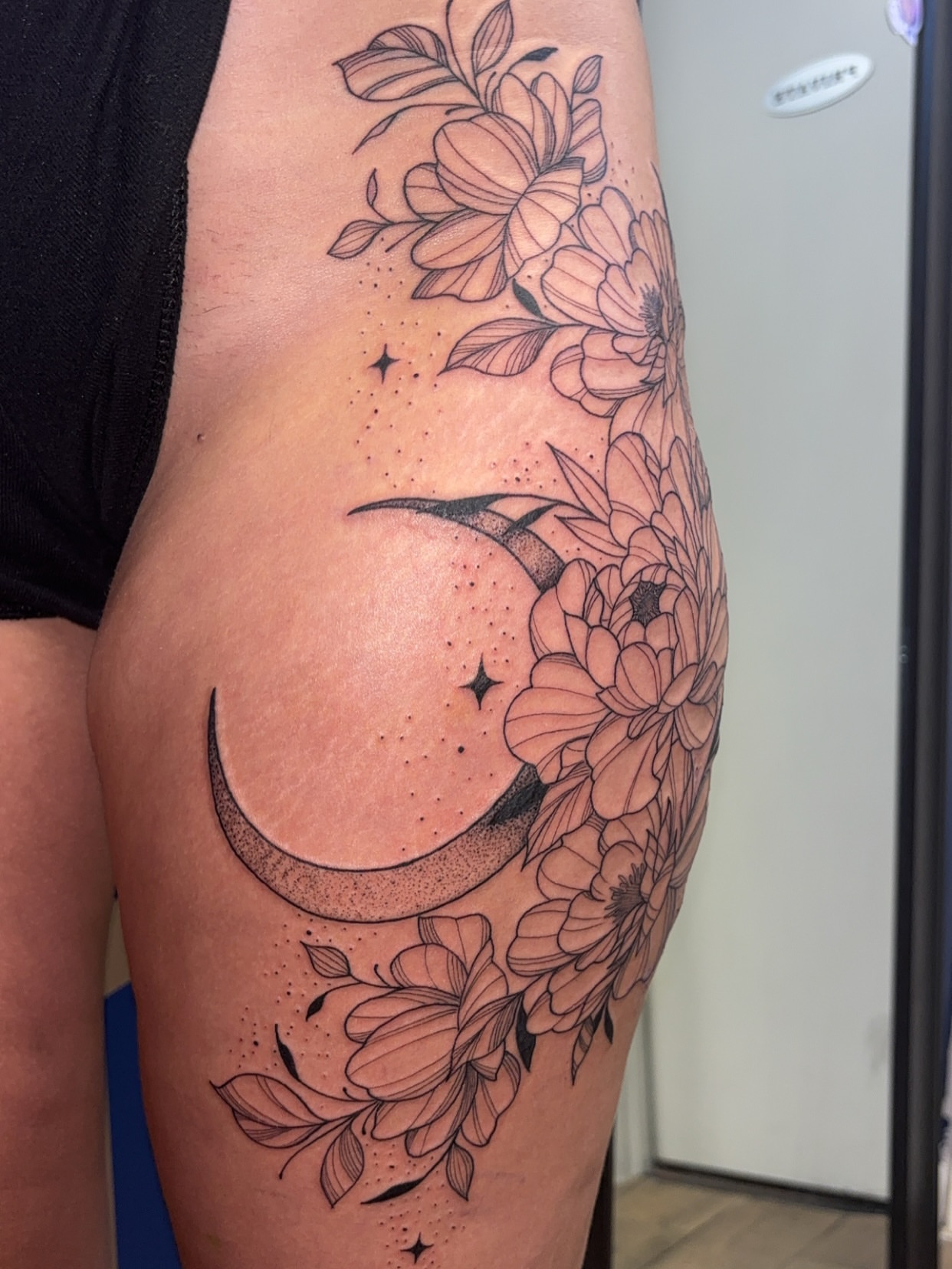 Moon and flowers dotwork tattoo on the thigh by ✨Cyerra Lynne✨