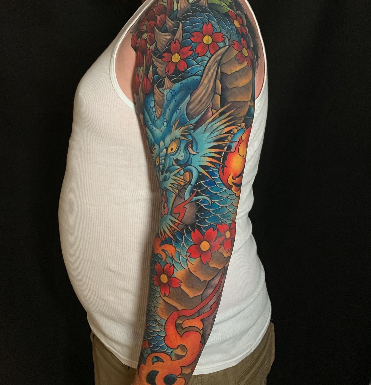 Dragon and flowers japanese irezumi tattoo on the upper arm by Pat Patterson Florida Tattoo Artist