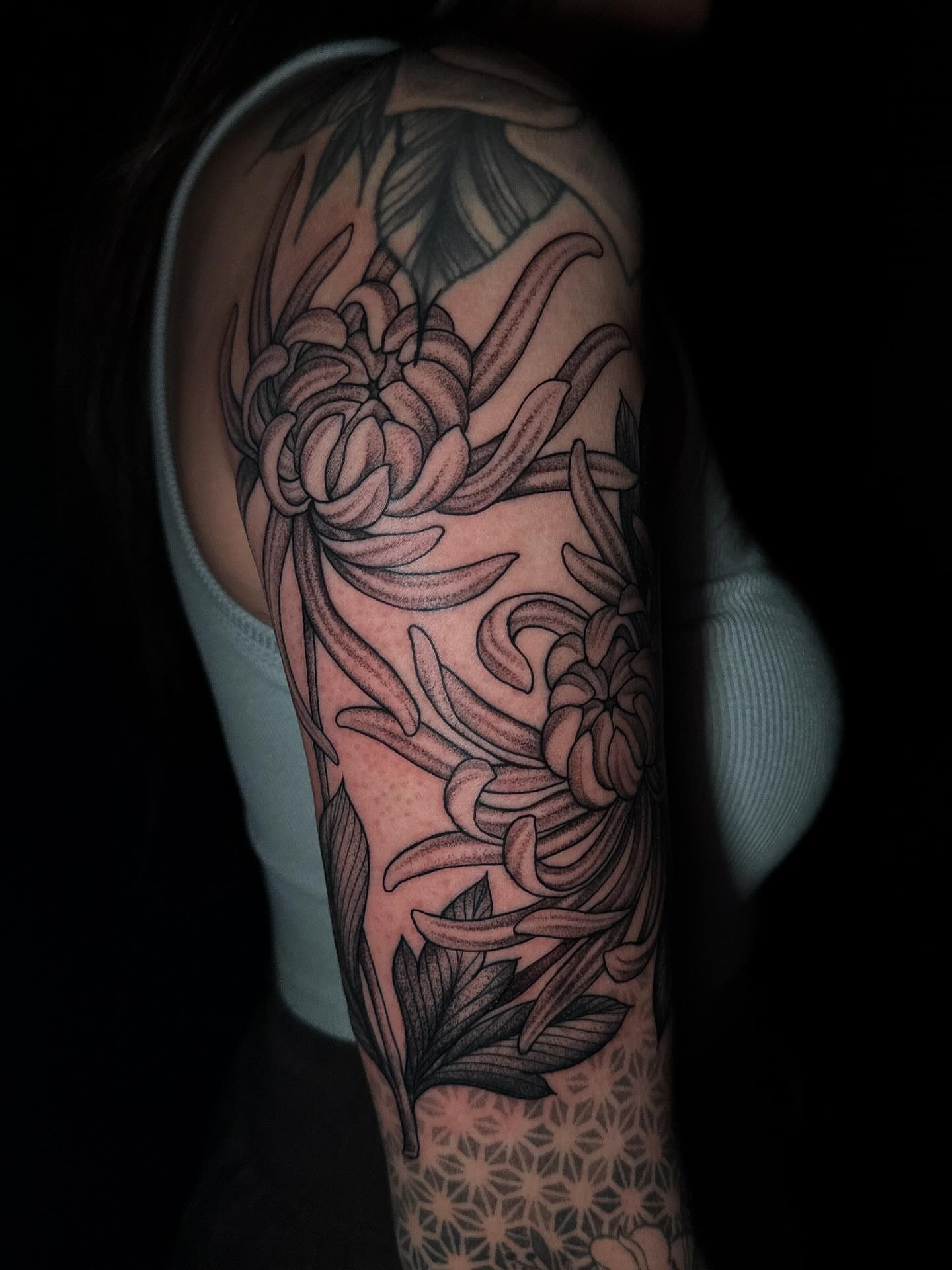 Chrysanthemum black and grey tattoo on the forearm by Amber