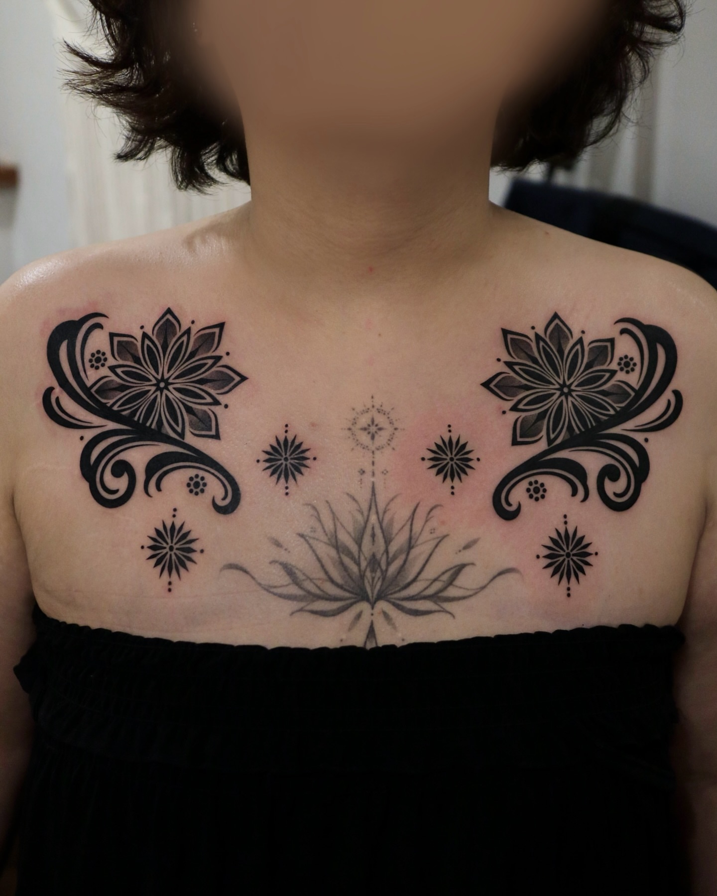 Lotus flowers and stars black and grey tattoo on the chest by Seoul tattoo