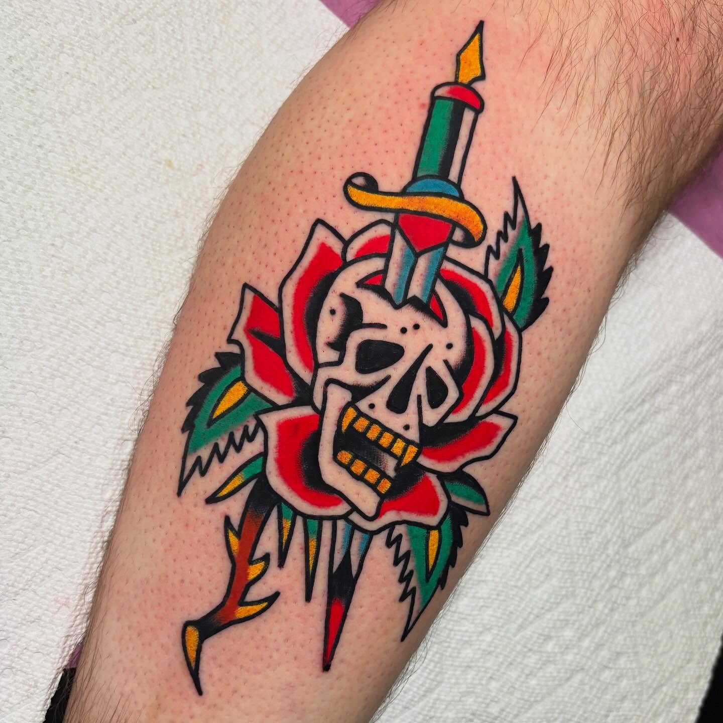 Skull and rose American traditional tattoo on the forearm by Mr. Brent