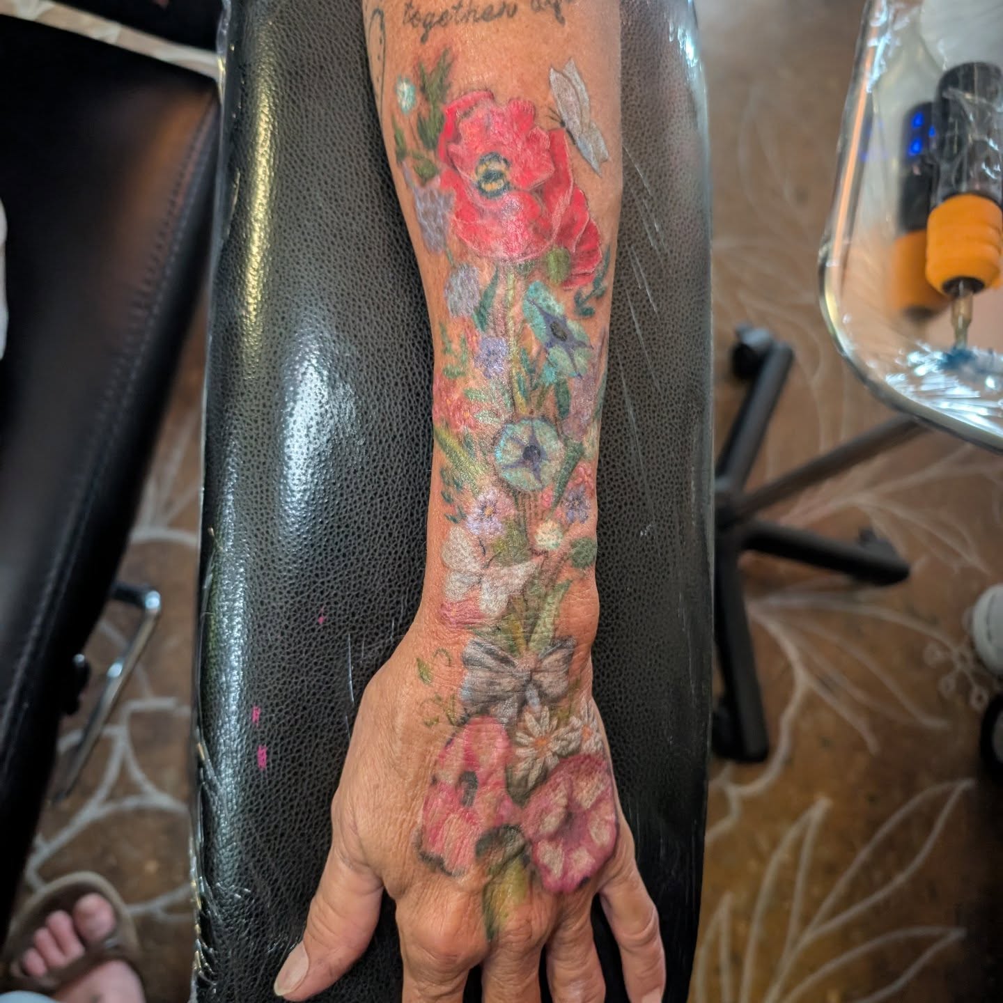 Floral bouquet realism tattoo on the forearm by Cat
