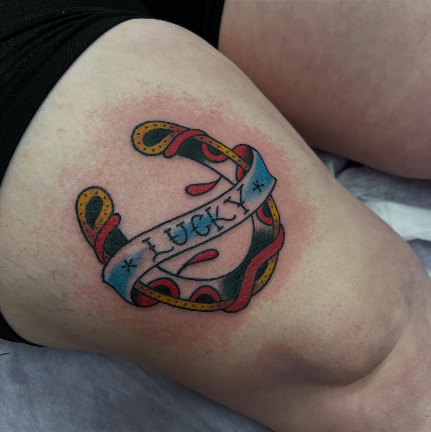 Anchor with ribbon American traditional tattoo on the thigh by doodle