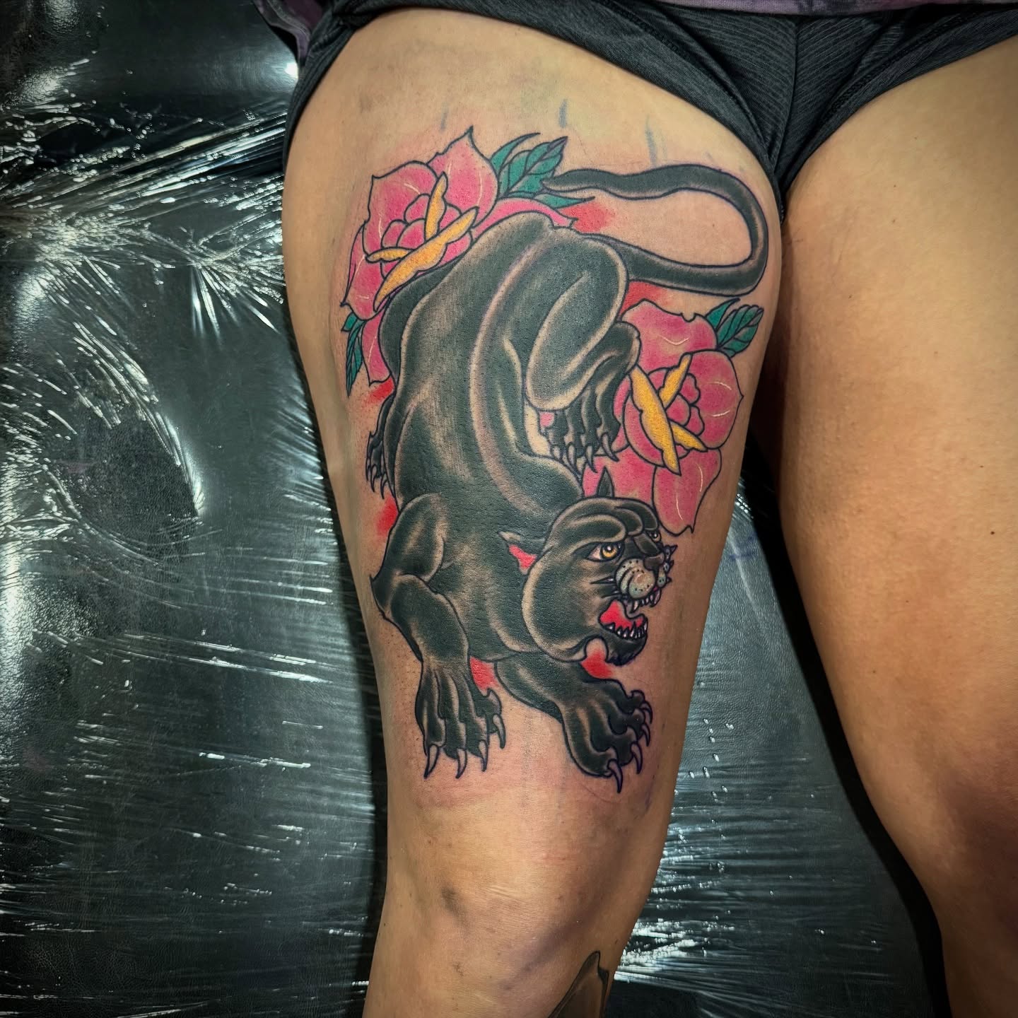Panther and roses American traditional tattoo on the thigh by David C. McGhee