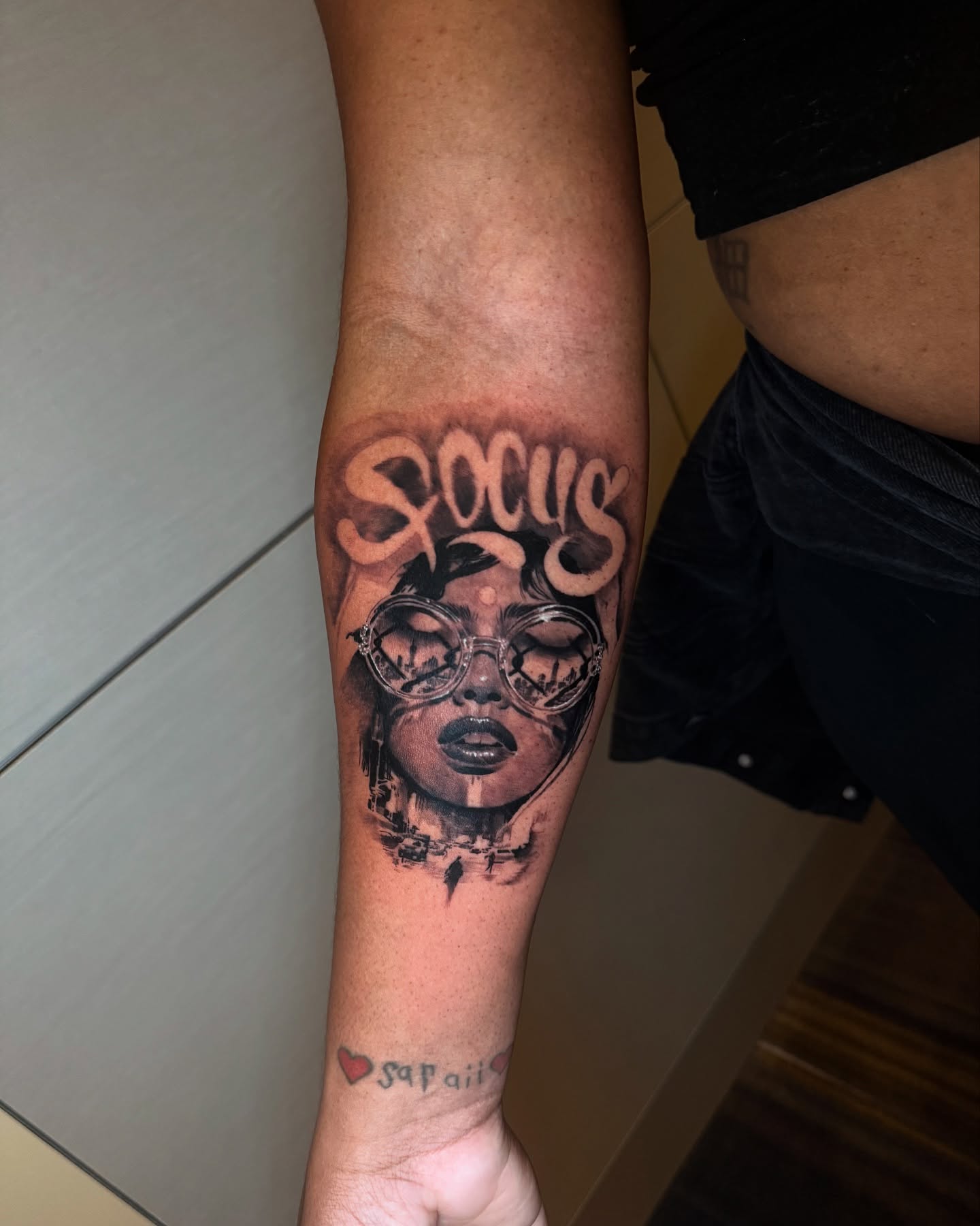 Woman with sunglasses realism tattoo on the forearm by Joel: Boston Tattoo Artist, Boston, Massachusetts