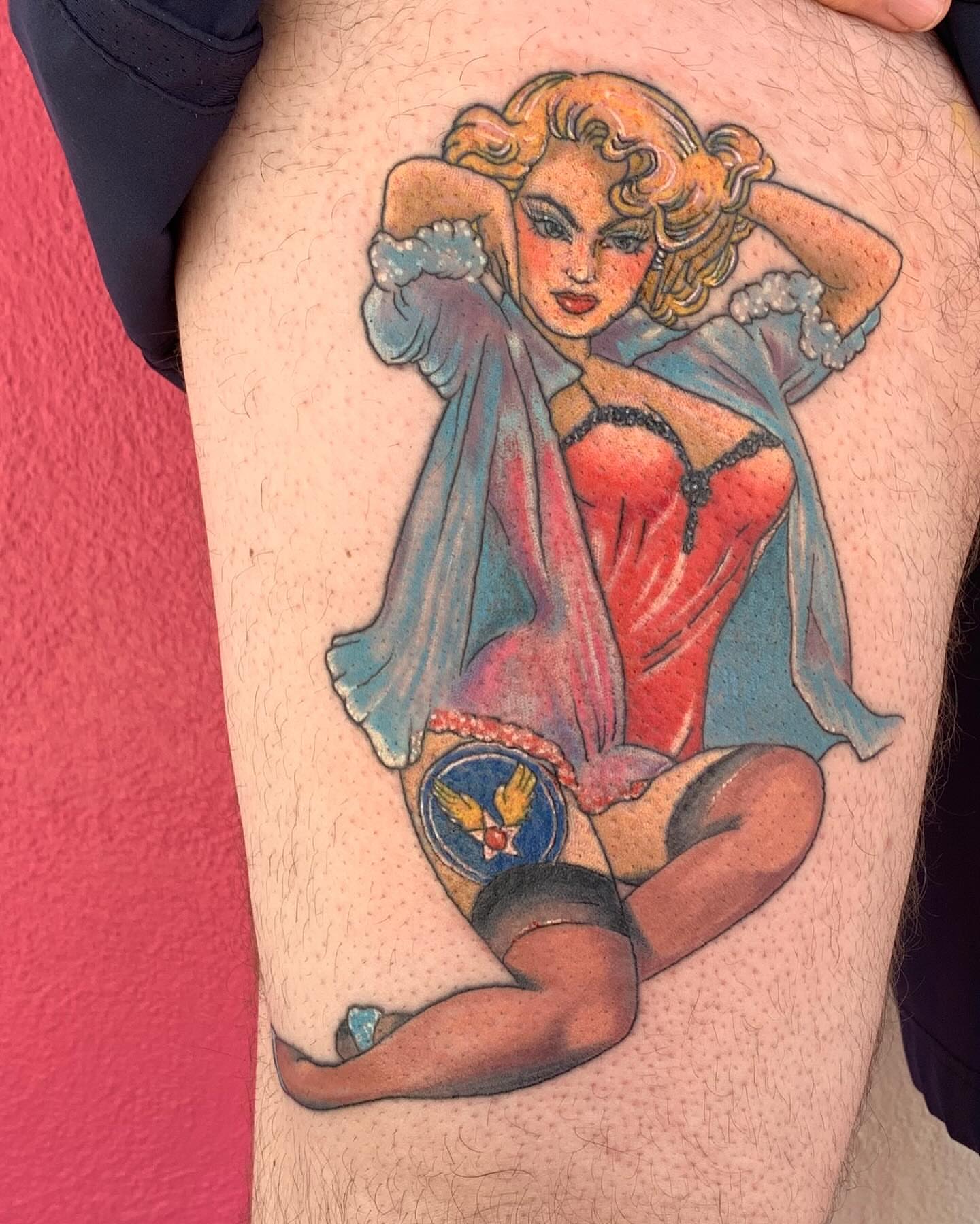 Pin-up girl American traditional tattoo on the thigh by Julie Bird