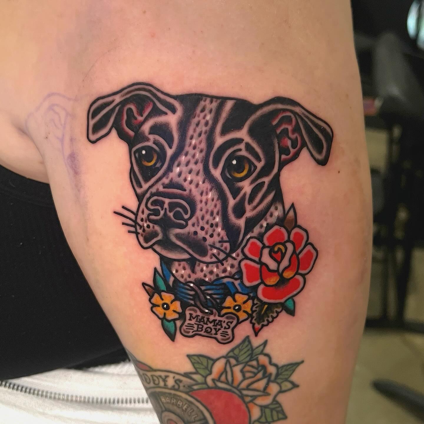 Pitbull and roses American traditional tattoo on the thigh by Benjamin Ward