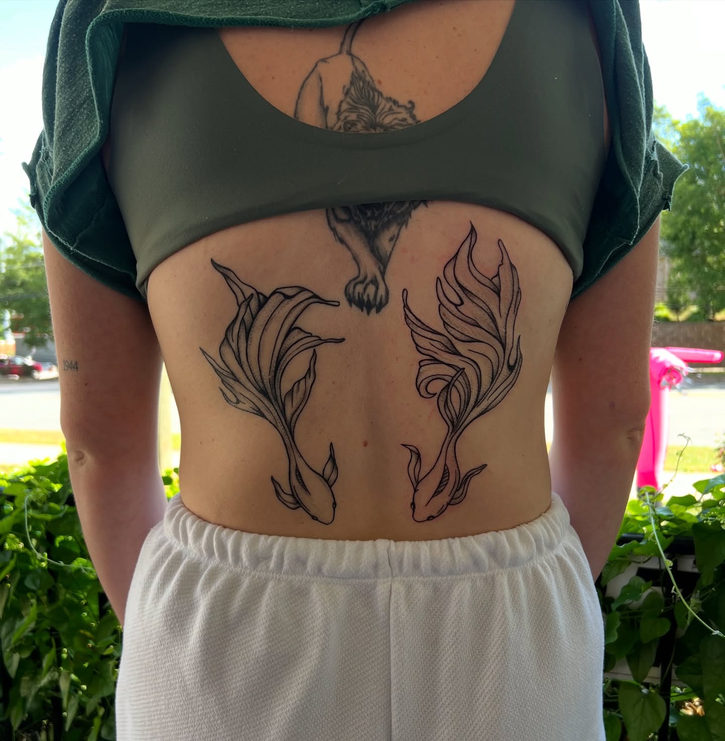 Fishes and wolf black and grey tattoo on the torso by Rose DeLisse