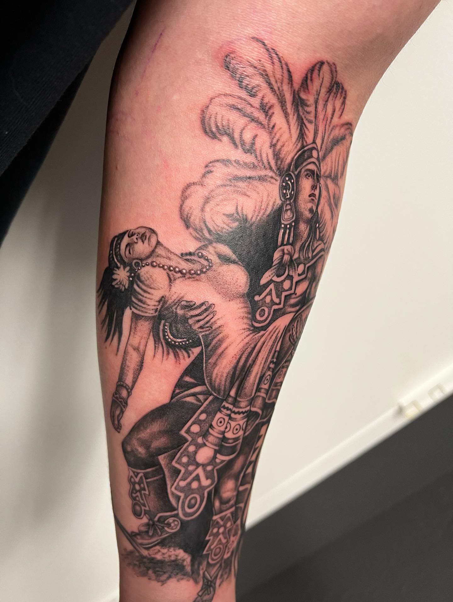 Indigenous warrior and dancer realism tattoo on the forearm by Hugo Ruiz-Esparza