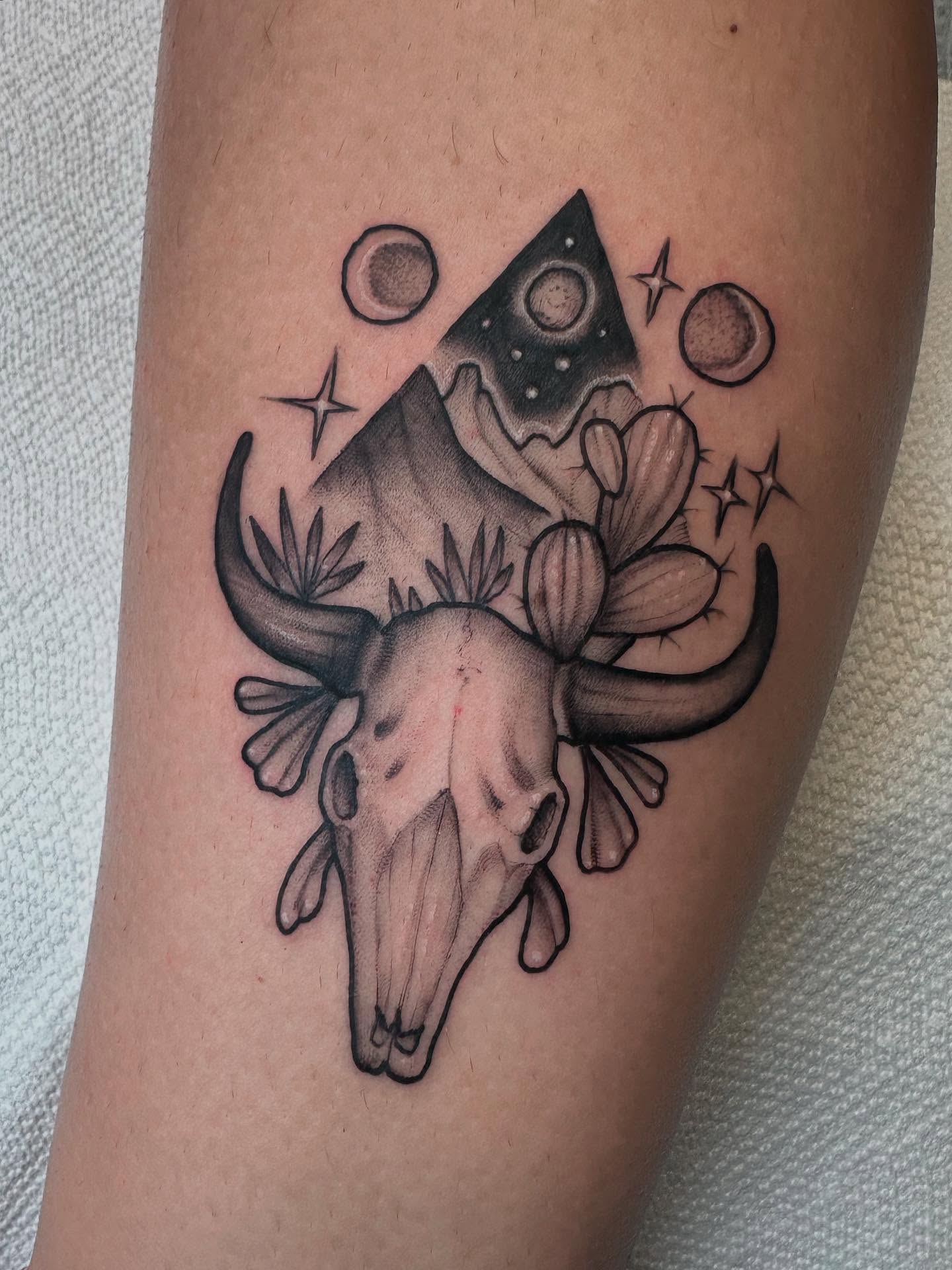 Bull skull and cactus geometric tattoo on the forearm by Lawrence Edwards