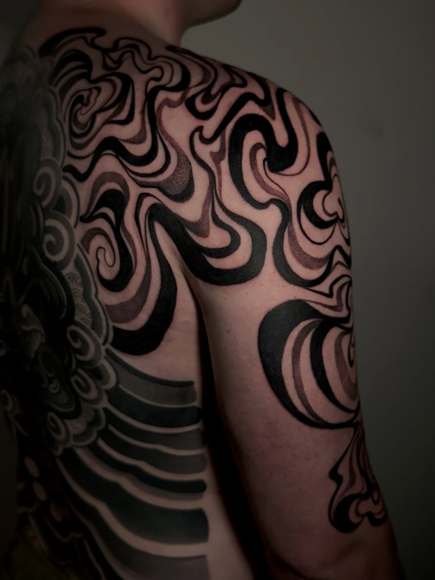 Abstract swirls black and grey tattoo on the shoulder by Crystal, Las Vegas, Nevada
