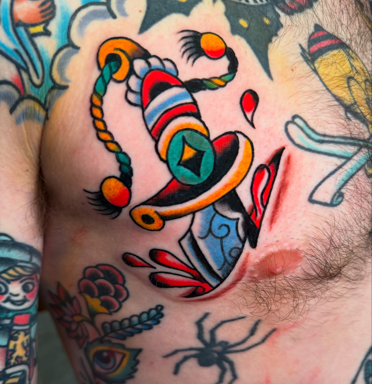 Clown nose American traditional tattoo on the chest by πππ’π―π’π¨ πππΆπ©π¬π―π, Manchester, New Hampshire