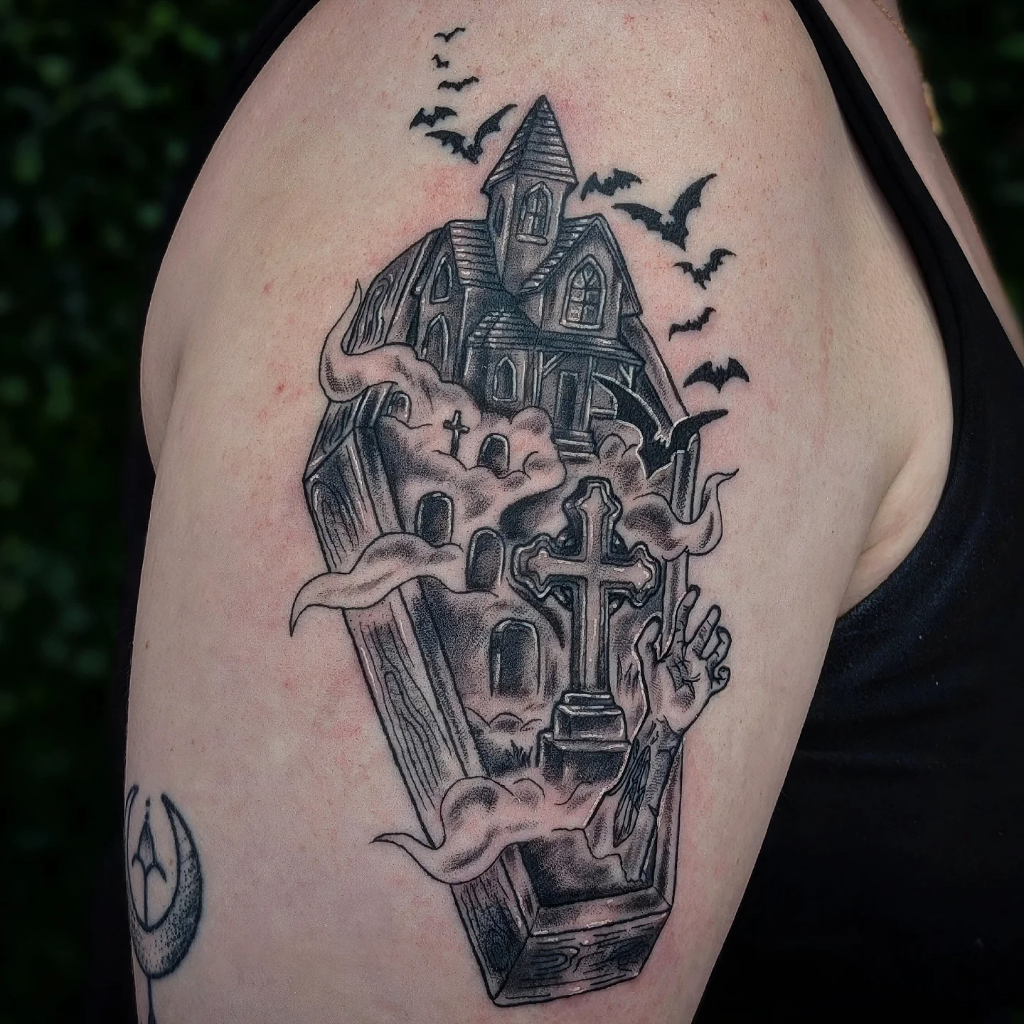 Haunted house and cross dark realism tattoo on the shoulder by Marlayna Connelly