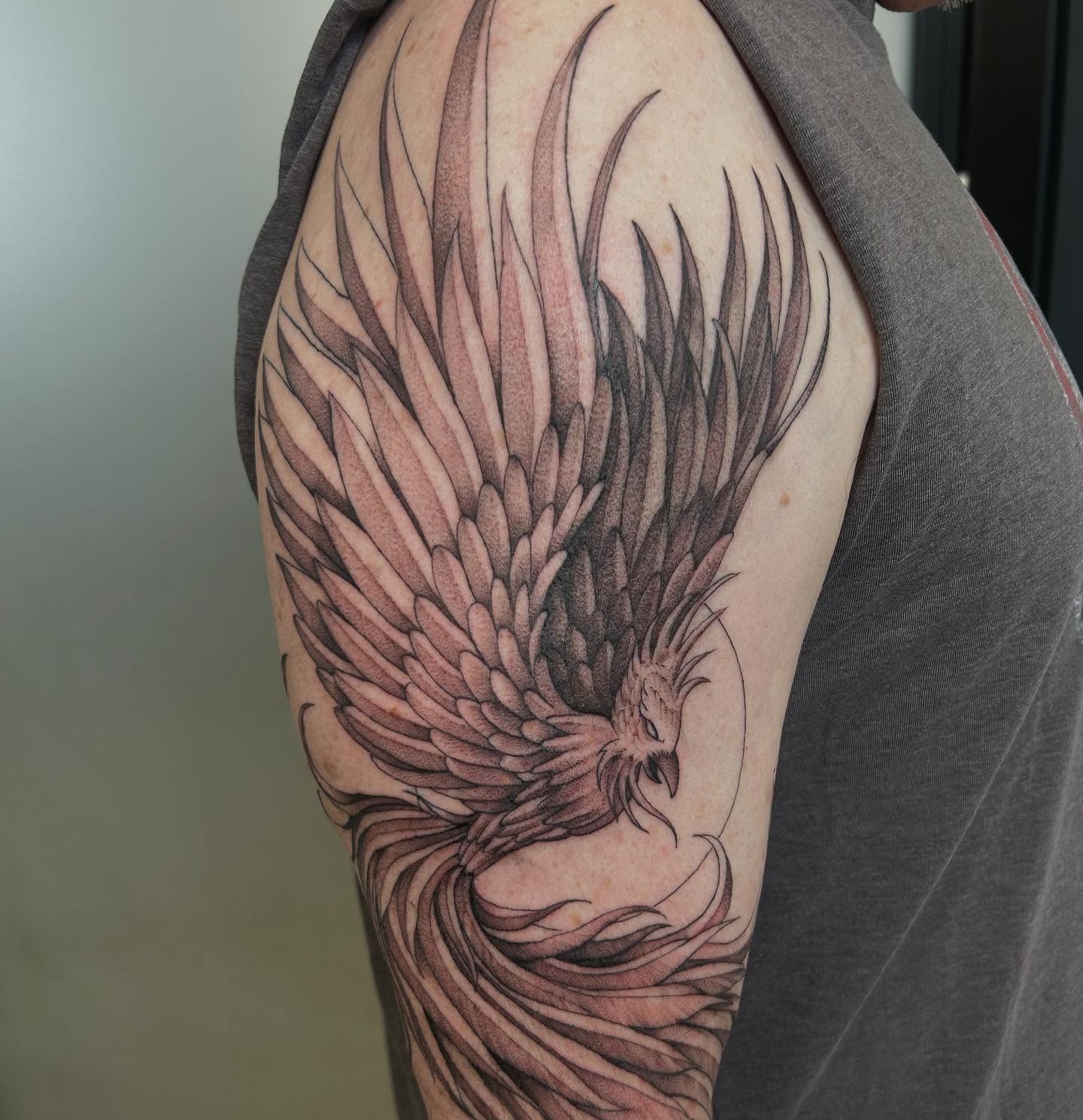 Phoenix black and grey tattoo on the shoulder by Olivia Fox