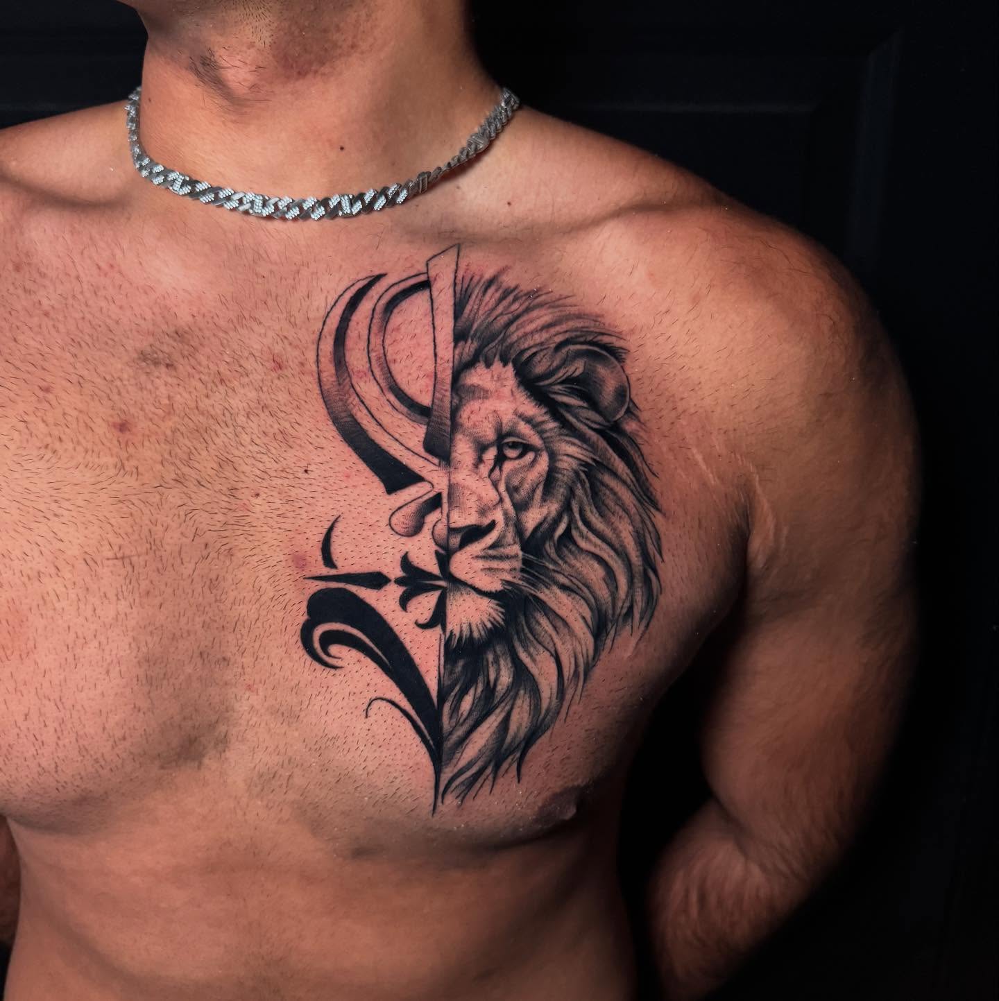 Lion and sword realism tattoo on the chest by Nate Masi