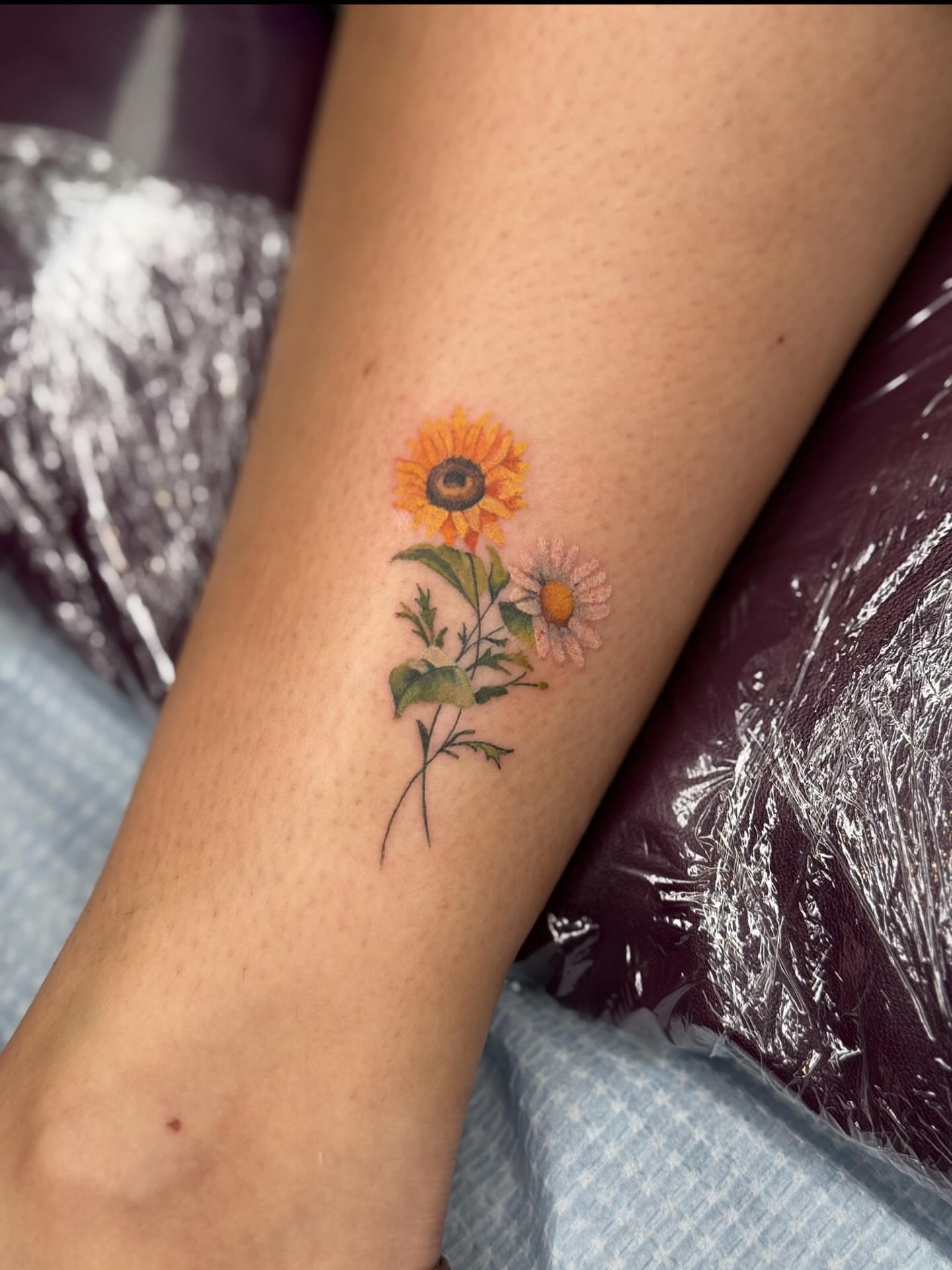 Sunflower and daisy realism tattoo on the forearm by Ashley Hsiung *Panda*