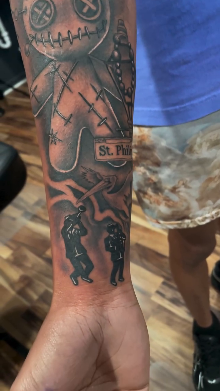 Voodoo doll and script Chicano tattoo by Blake