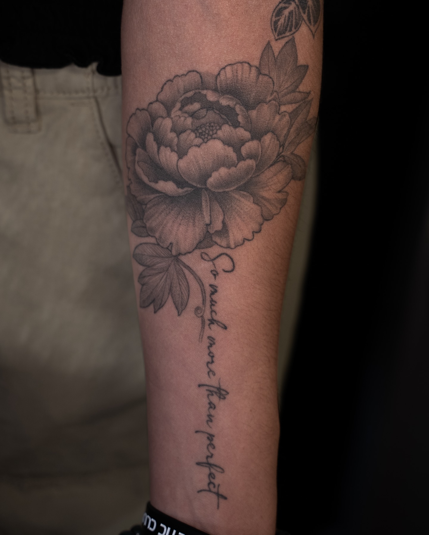 Peony flower black and grey tattoo on the forearm by Chris Estrada