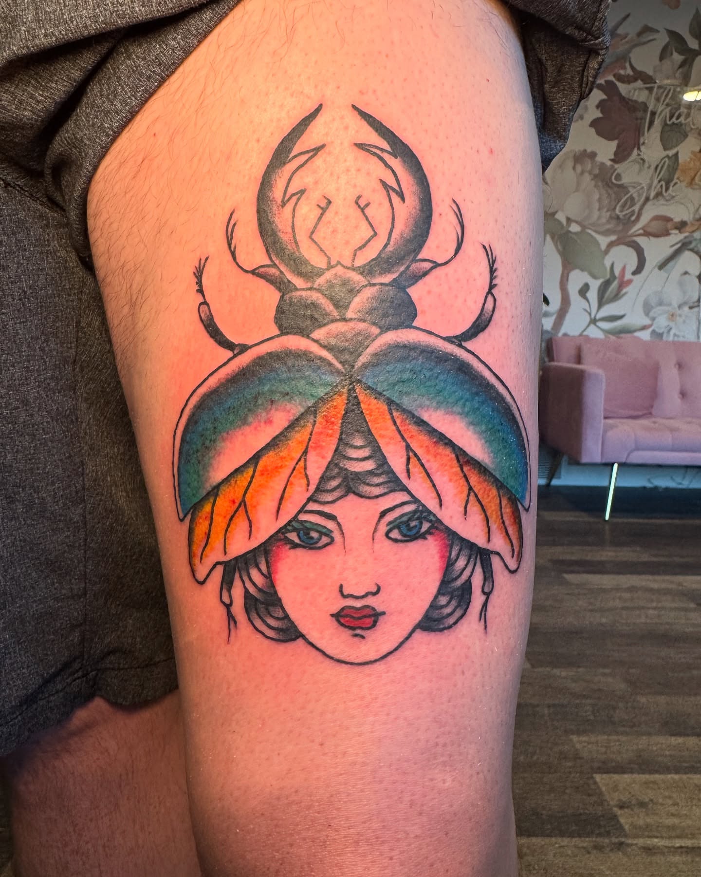 Woman with beetle American traditional tattoo on the thigh by Kinzi Brown