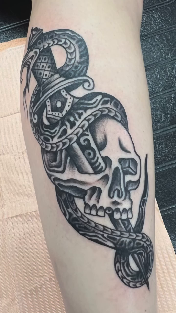 Skull with snake realism tattoo by Don Peddicord