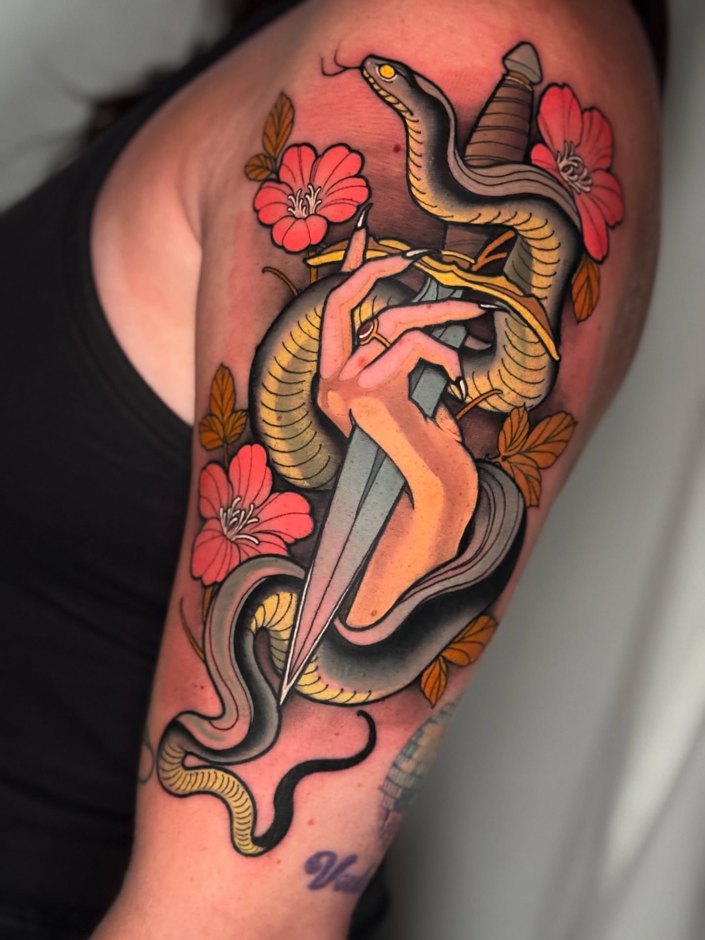 Snake and dagger American traditional tattoo on the upper arm by Neotrav Tattoos