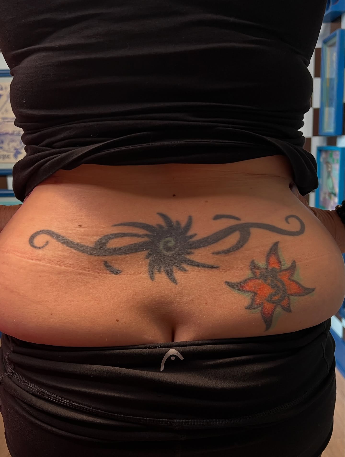 Sun and star black and grey tattoo on the torso by Bombay Pain Co.