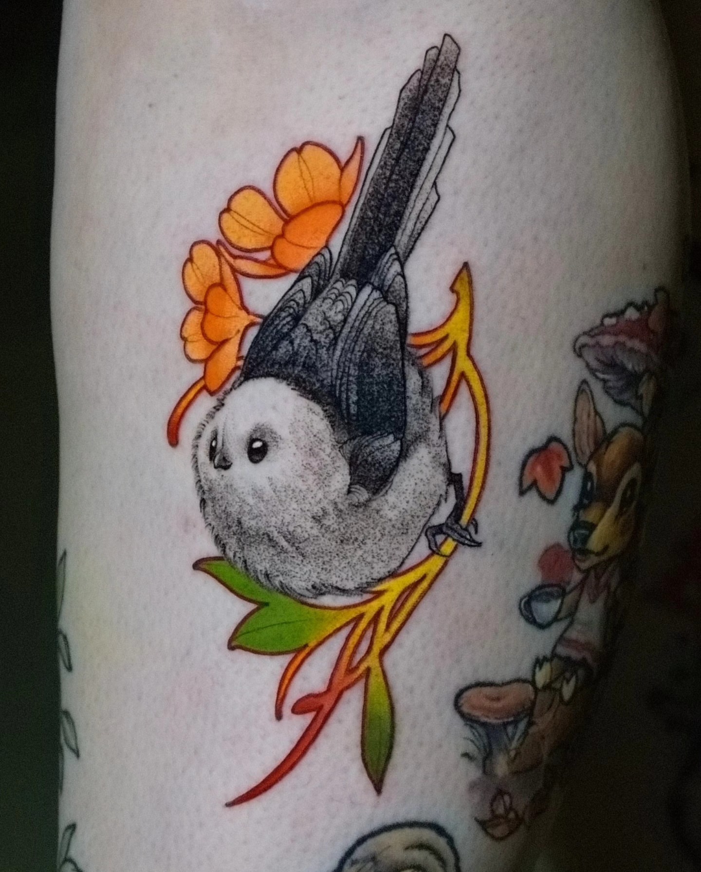 Bird with flowers realism tattoo on the forearm by Justin Byrd, Kansas City, Missouri