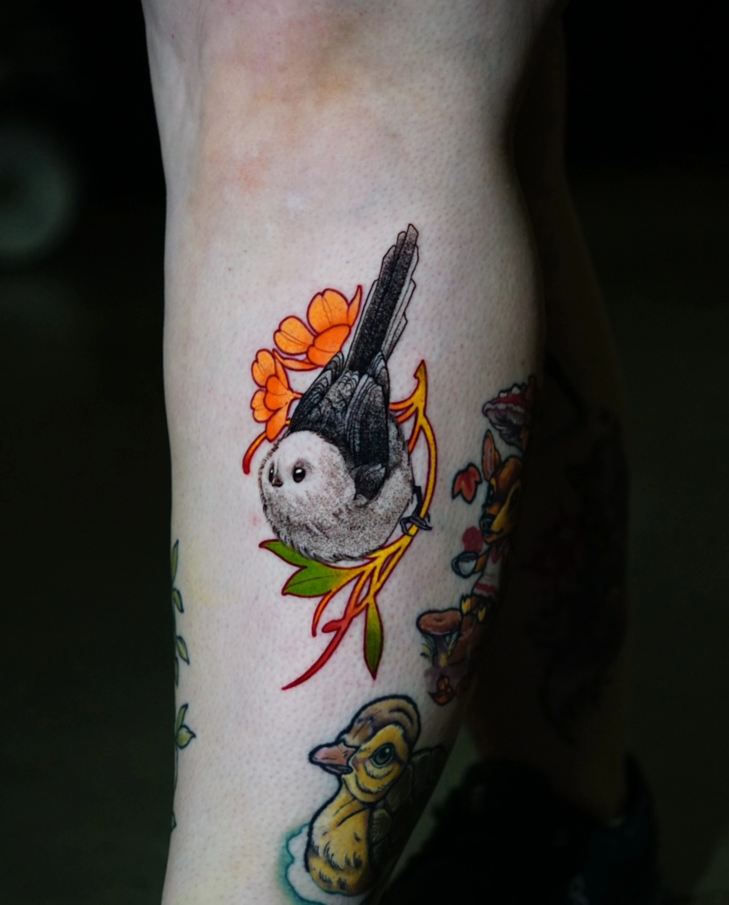 Bird and flowers new school tattoo on the forearm by Justin Byrd, Kansas City, Missouri
