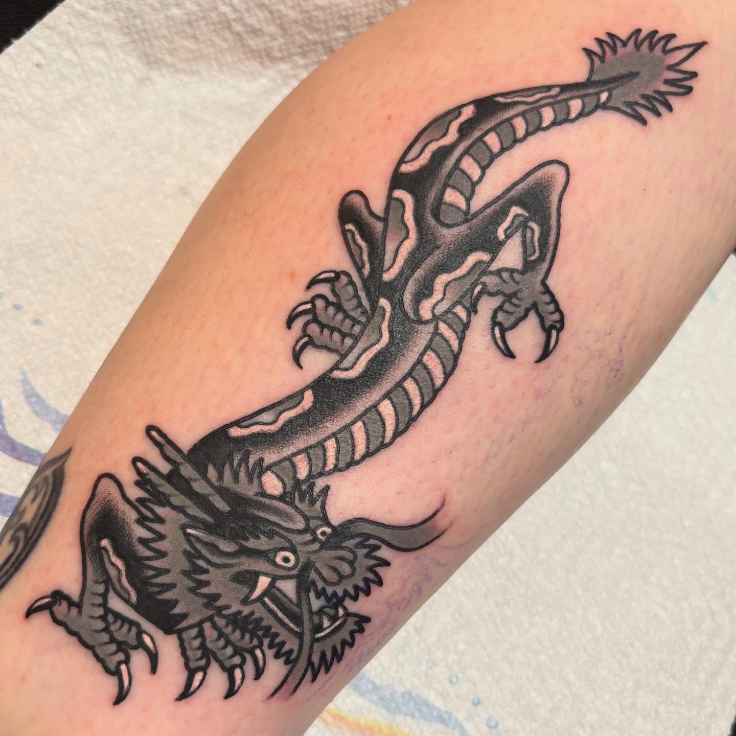Dragon American traditional tattoo on the forearm by @dannydoestattoos