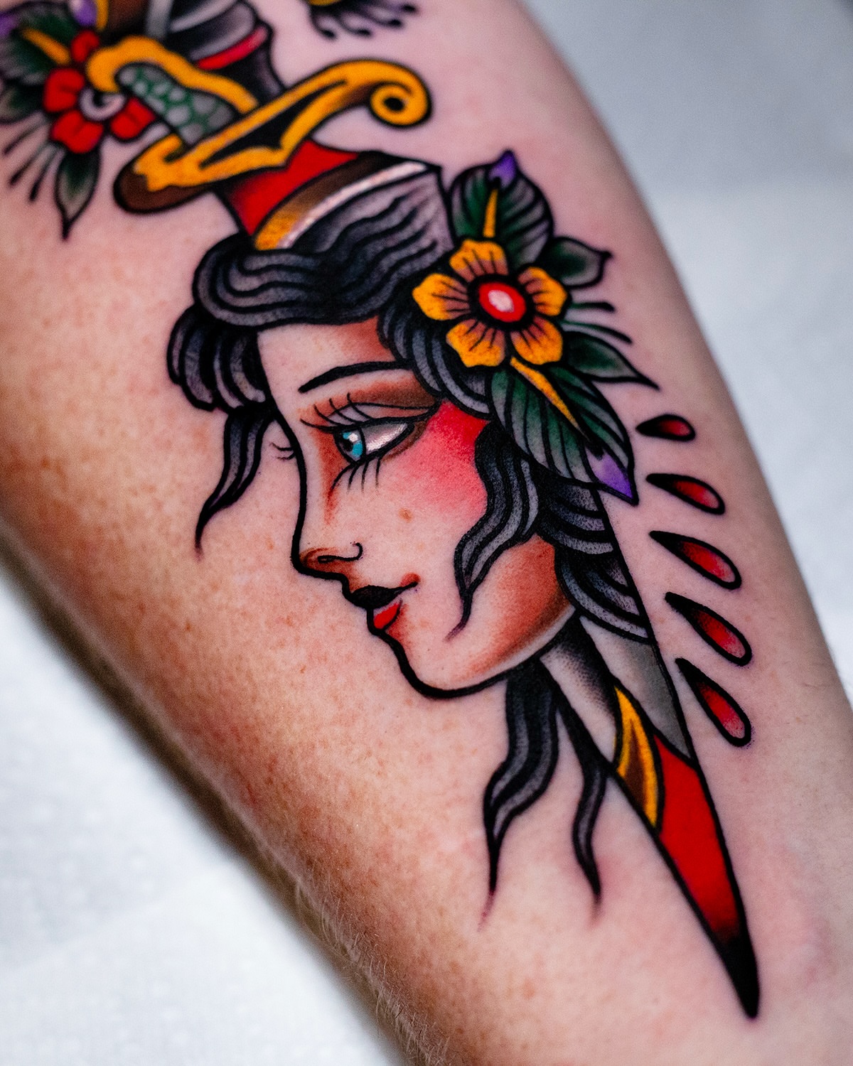 Woman with hat American traditional tattoo on the forearm by Miguel Comin