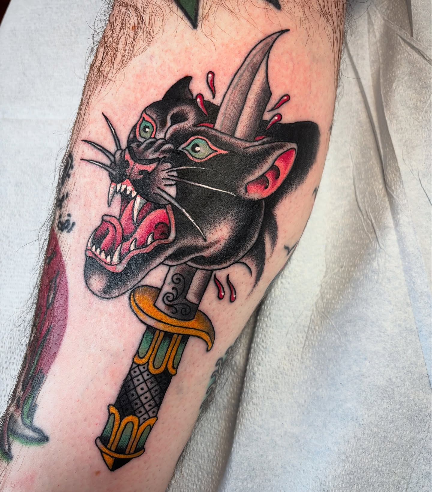 Panther head American traditional tattoo on the forearm by Adam Bailey, Portland, Oregon