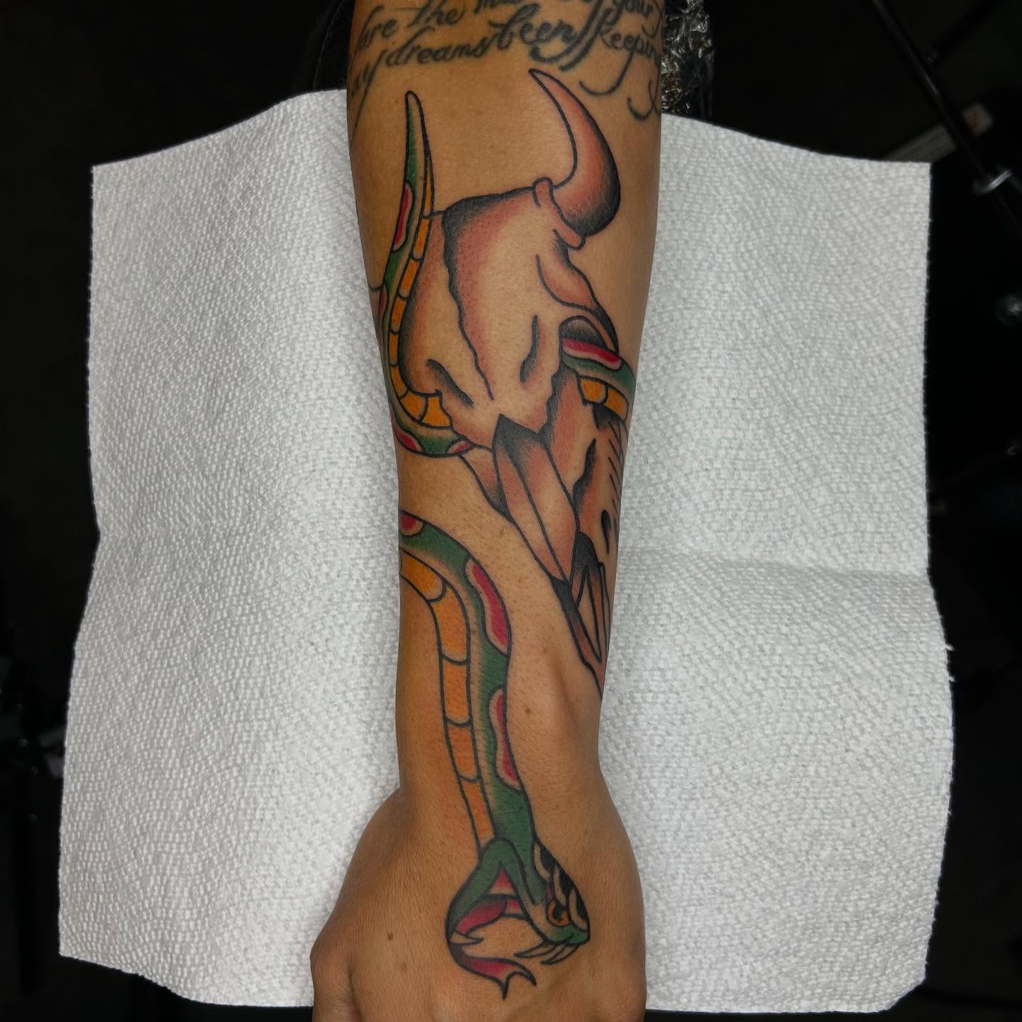 Bull skull and snake American traditional tattoo on the forearm by Bregan ✨