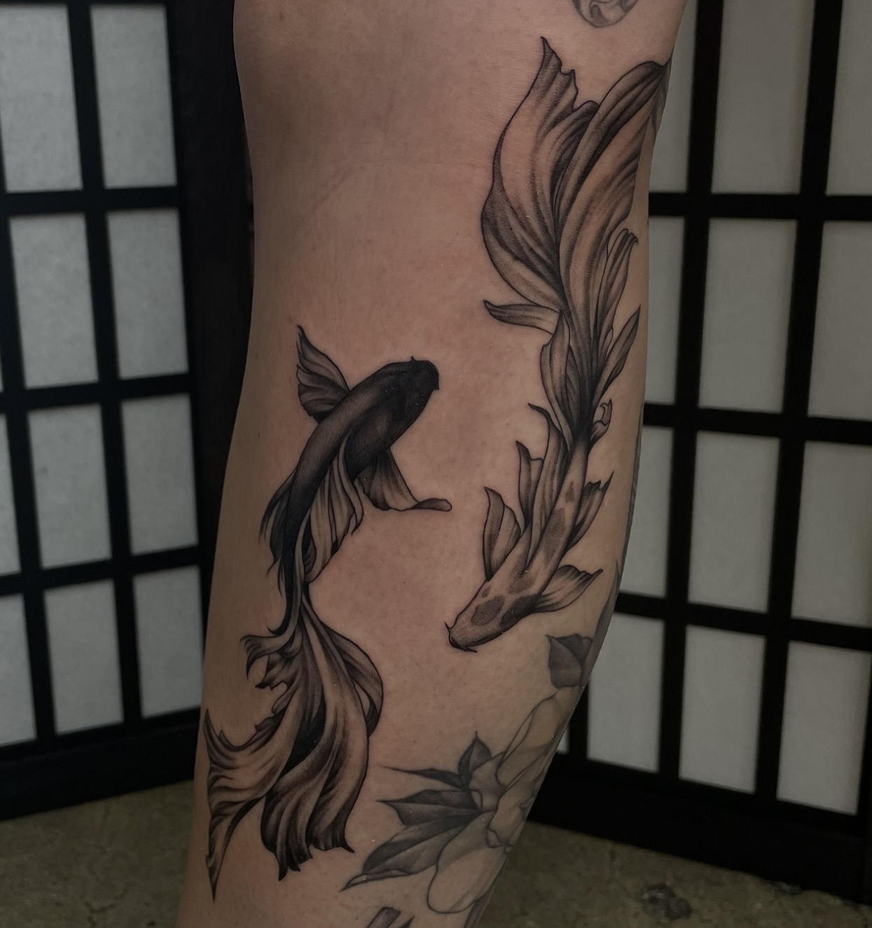 Koi fish and lotus realism tattoo on the forearm by kaylee