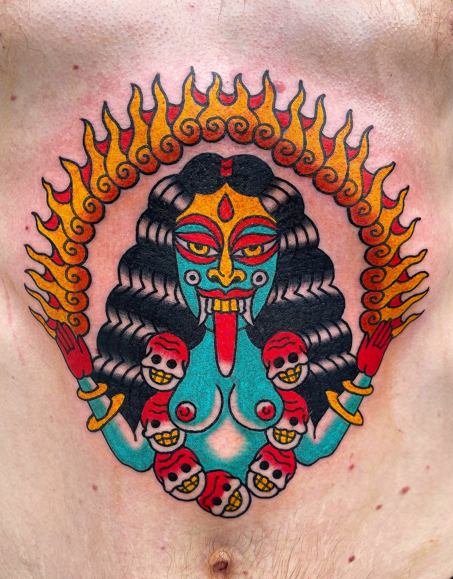Demoness with skulls American traditional tattoo on the chest by Swasthik Iyengar, New York, New York