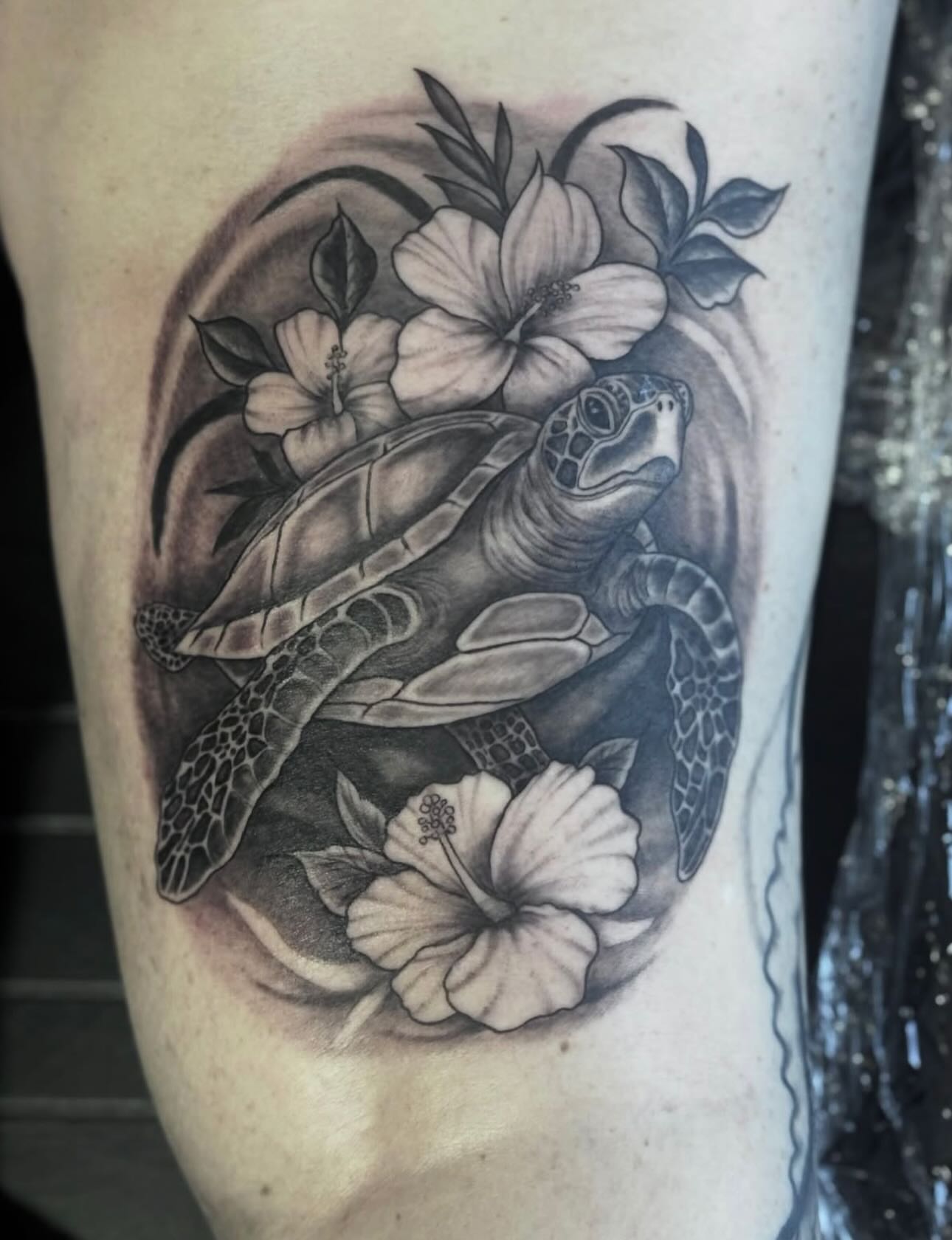 Sea turtle and hibiscus flowers realism tattoo on the thigh by @carissaetattoos