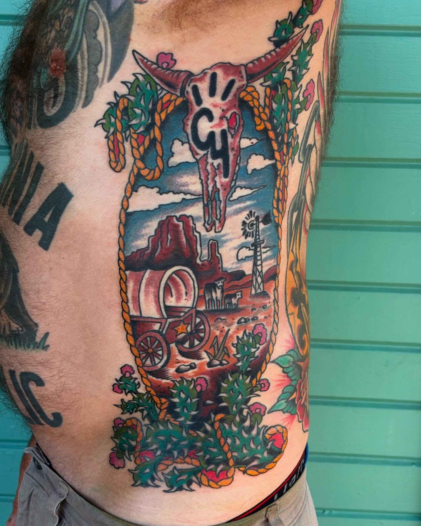 Western landscape American traditional tattoo on the chest by Nick Rodin