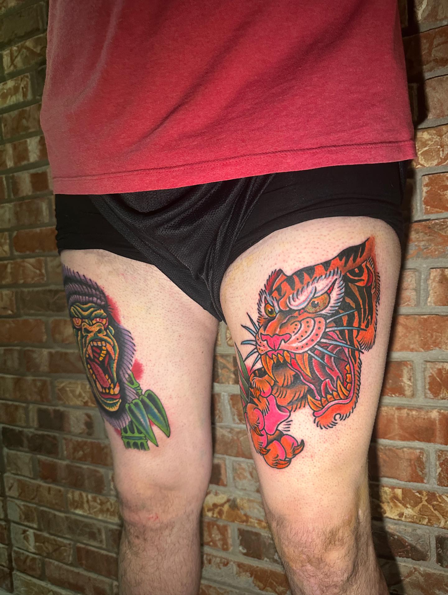 Tiger and gorilla American traditional tattoo on the thigh by ᴄʜʀɪs ᴀᴠᴇʀᴀ