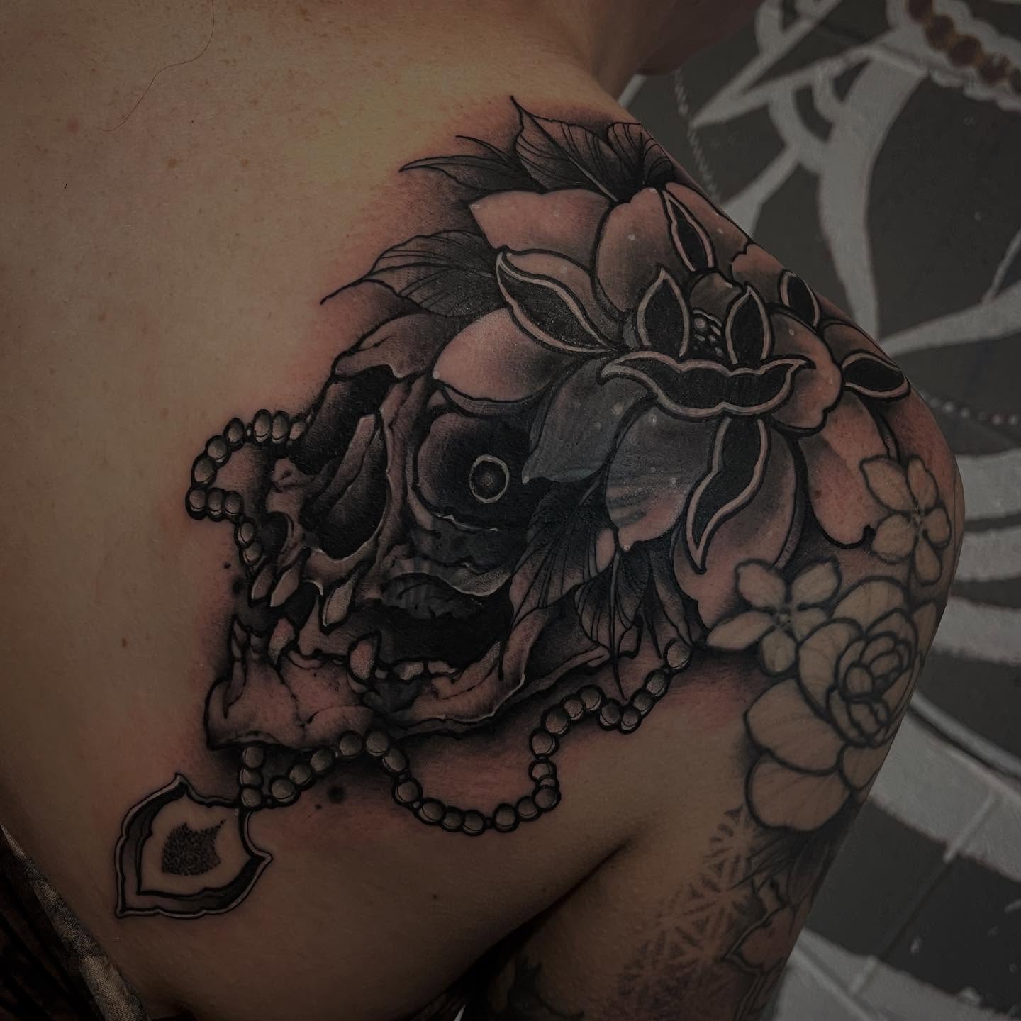 Skull and flowers realism tattoo on the shoulder by Brandon Mola, Chicago, Illinois