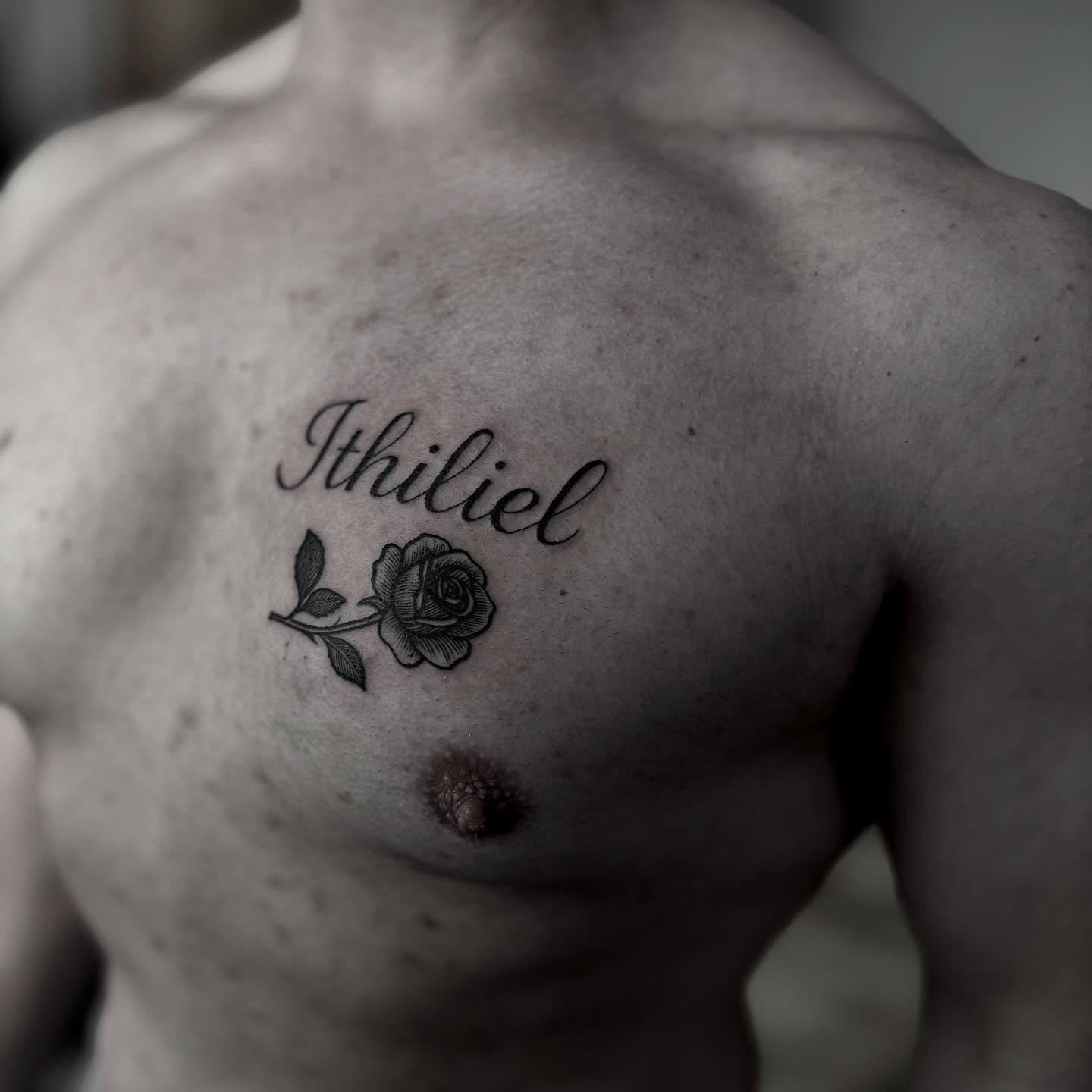 Rose and name black and grey tattoo on the chest by t a y l o r