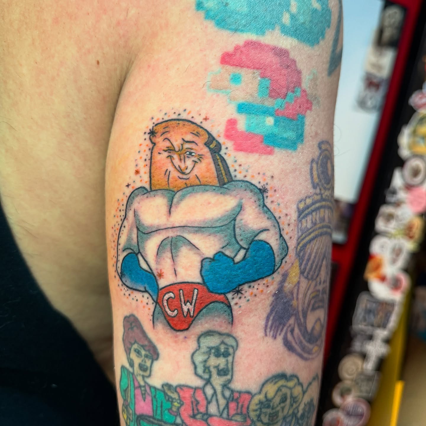 Muscular man with 'CW' shorts dotwork tattoo on the forearm by Angus Perfect, Philadelphia, Pennsylvania