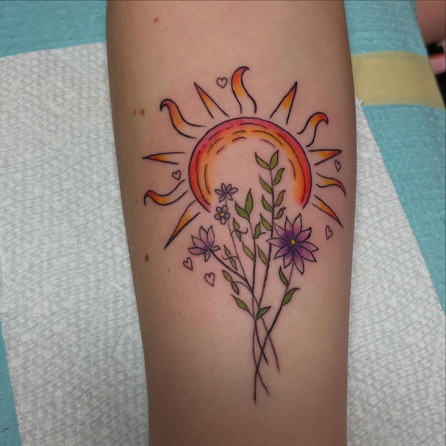 Sun and flowers new school tattoo on the forearm by Caitlin, Richmond, Virginia