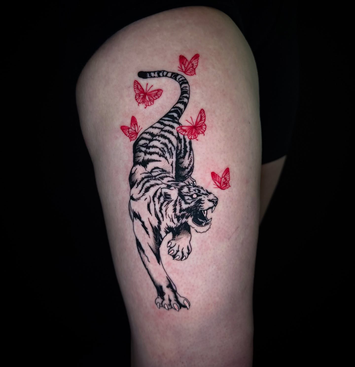 Tiger black and grey tattoo on the thigh by Honey