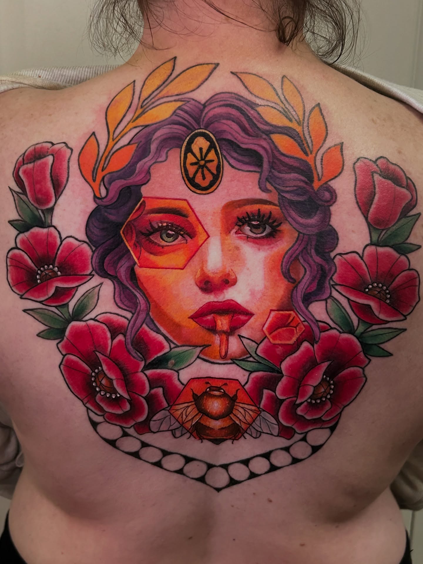 Woman with flowers American traditional tattoo on the back by Mando Castro