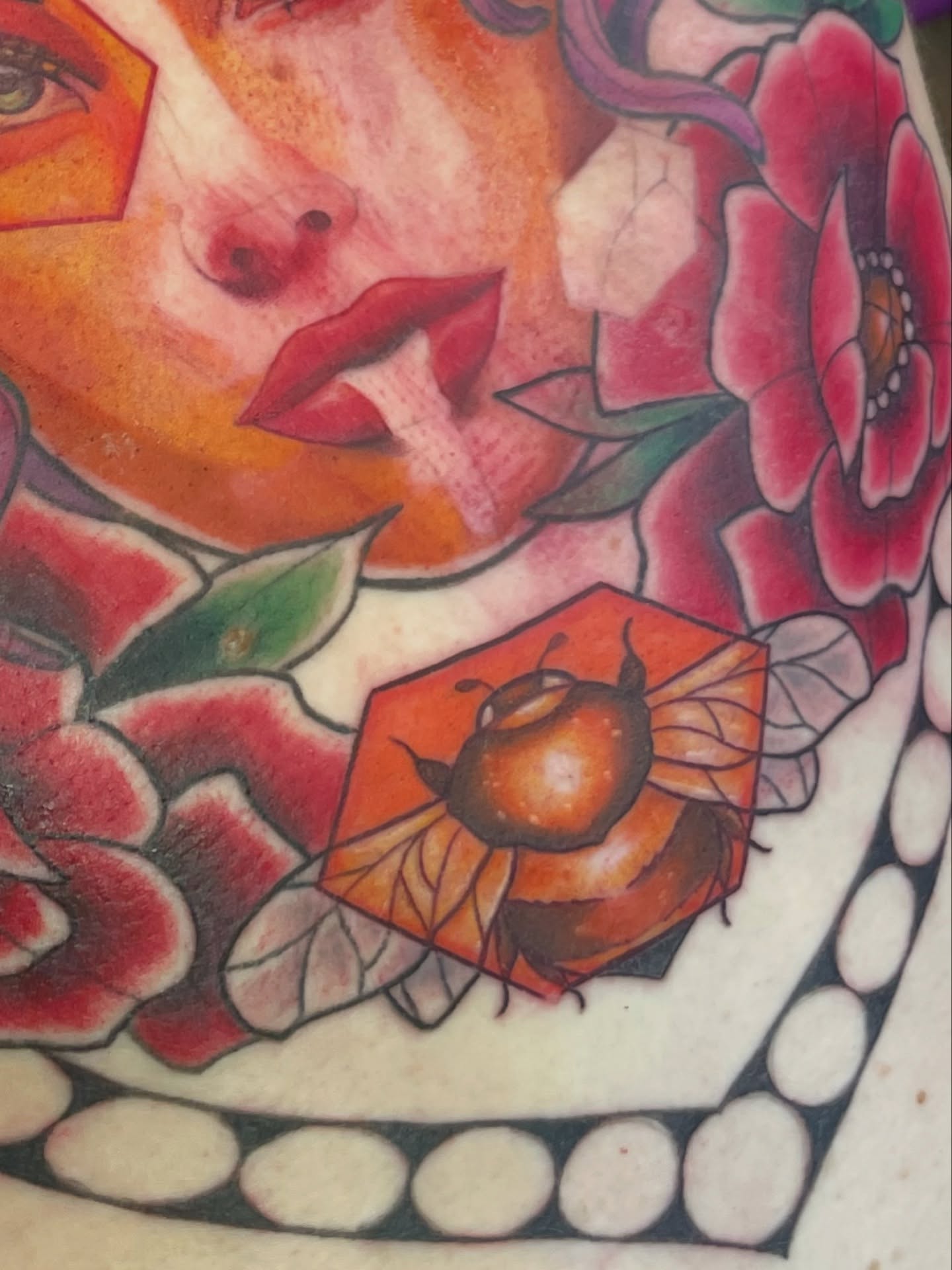 Woman with flowers and bee American traditional tattoo by Mando Castro