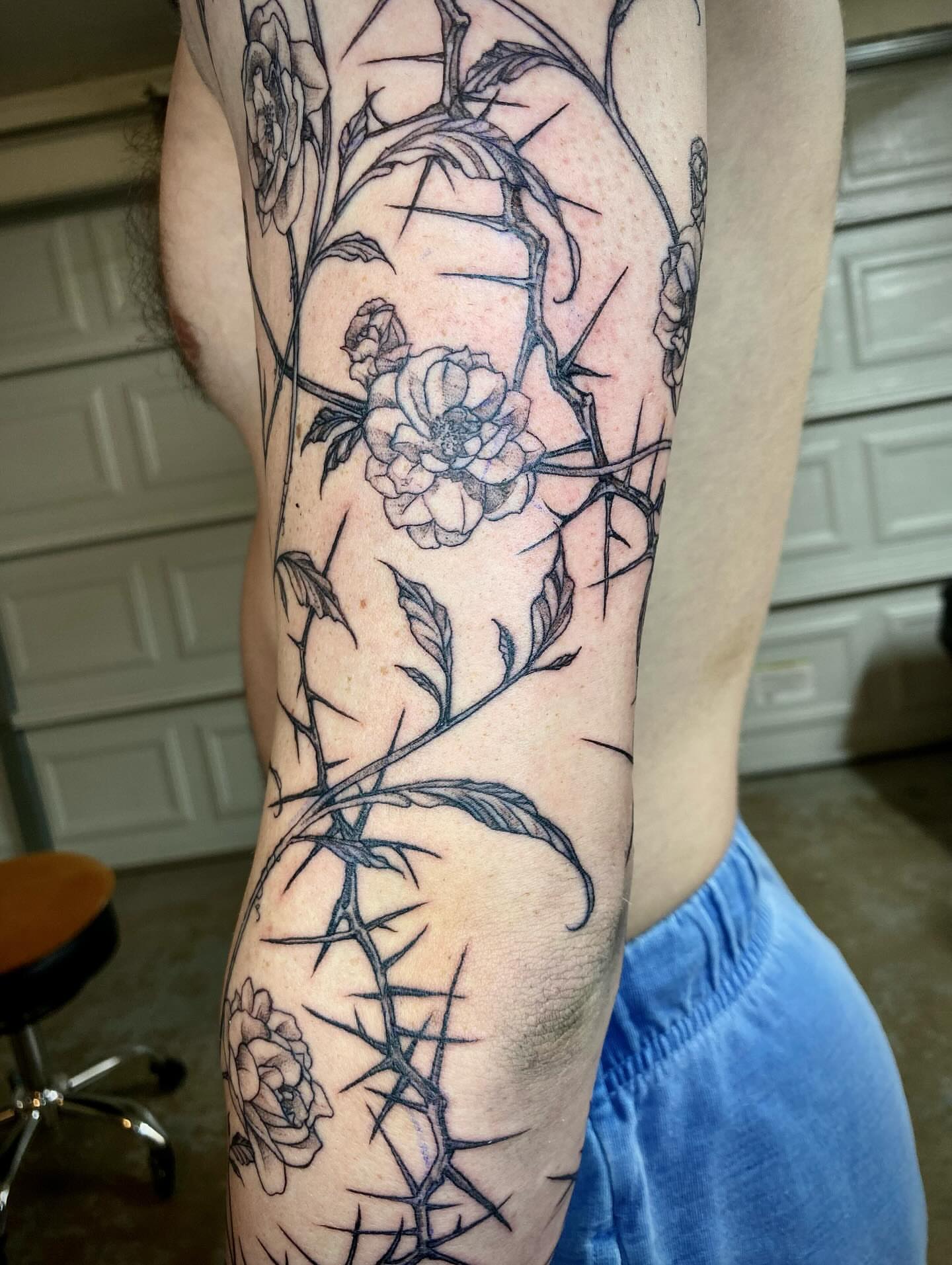 Flower and thorns black and grey tattoo on the forearm by Quin Walker