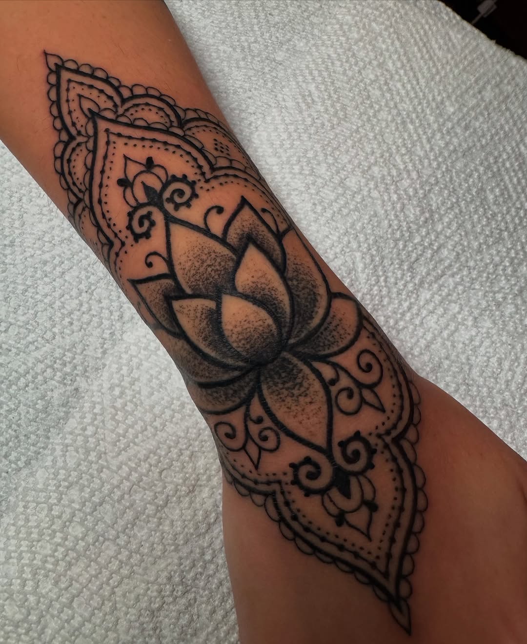 Lotus mandala ornamental tattoo on the forearm by Lisa Nikolopoulos, New York, New York