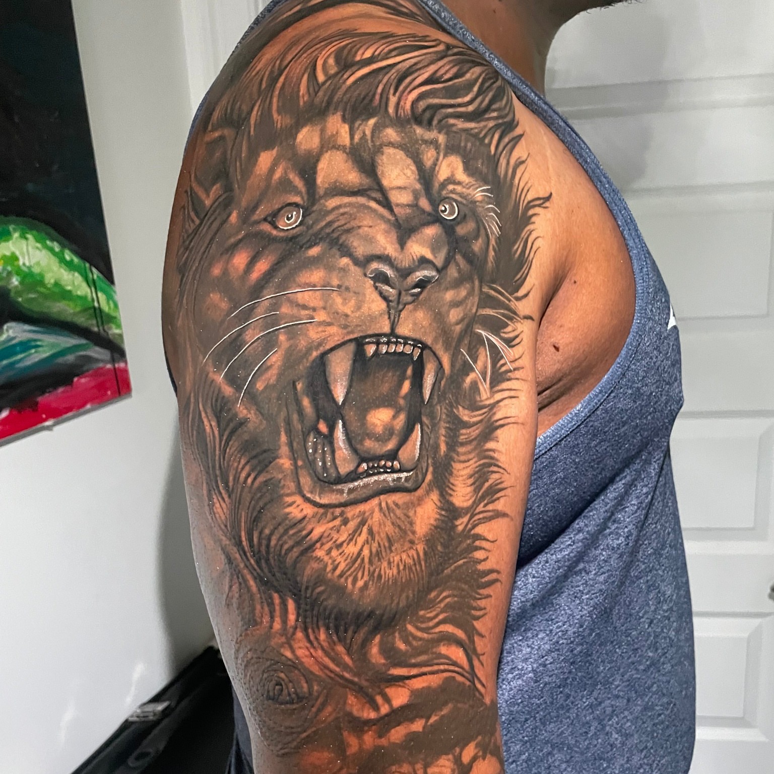 Roaring lion realism tattoo on the upper arm by Kimberly Parton- Chapel Hill Tattooer, Chapel Hill, North Carolina