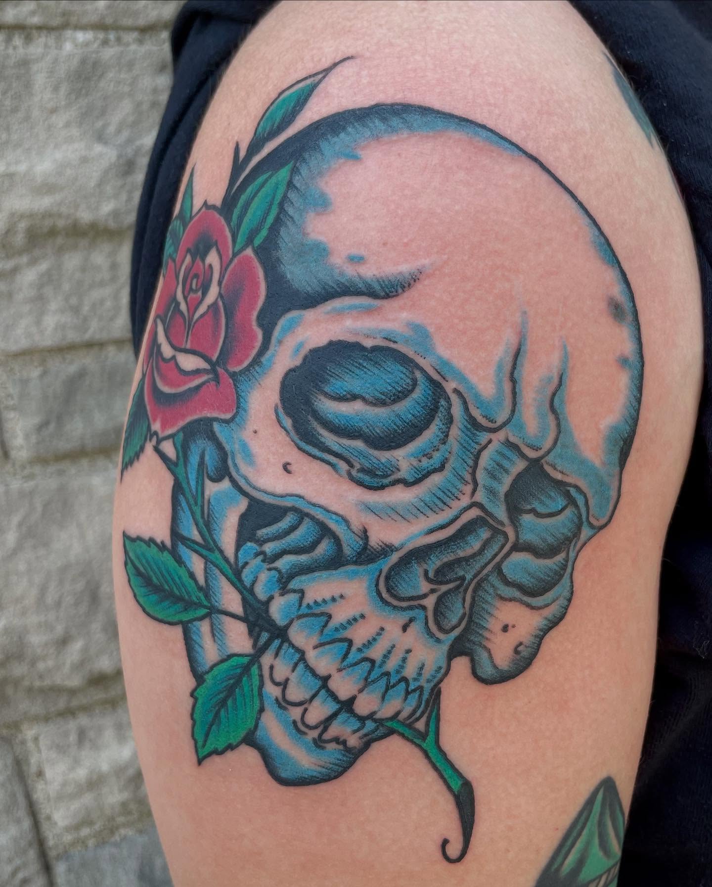 Skull and rose American traditional tattoo on the shoulder by Micheal McGlinchey