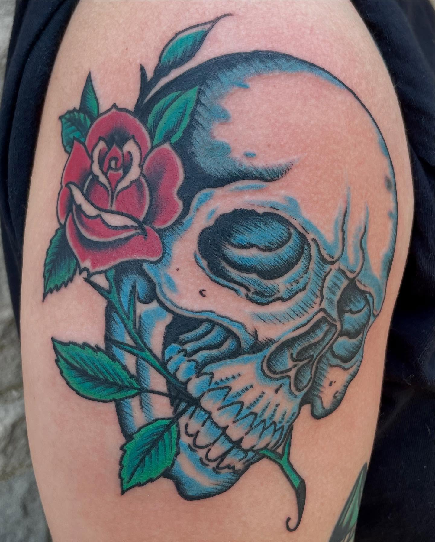 Skull and rose American traditional tattoo on the shoulder by Micheal McGlinchey