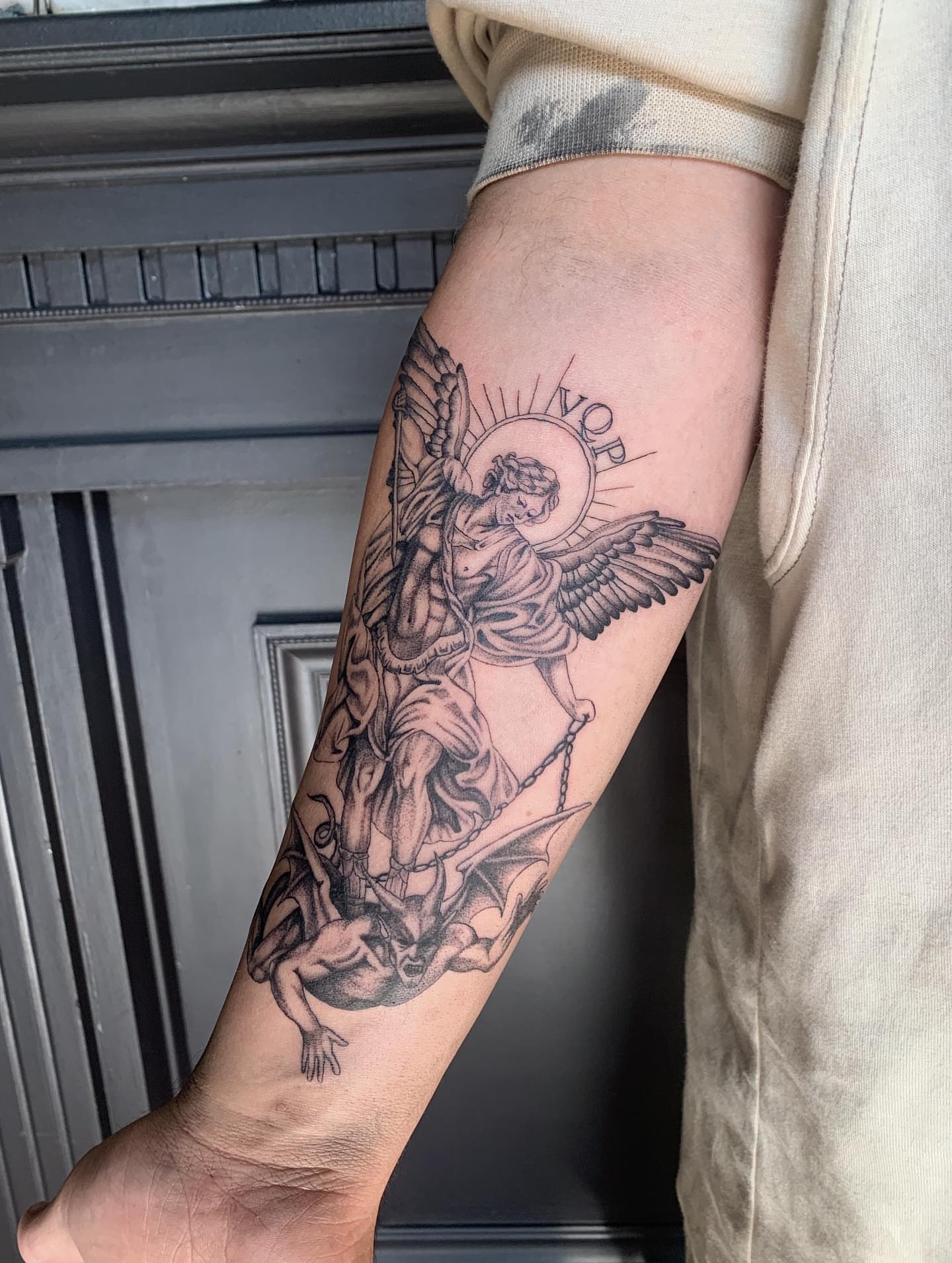 Angel and demon black and grey tattoo on the forearm by Jess, Midvale, Utah